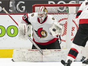 Goalie Matt Murray of the Ottawa Senators makes a glove save against the Vancouver Canucks during the third period of NHL action at Rogers Arena on April 22, 2021 in Vancouver, Canada.