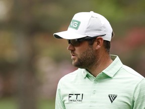 Corey Conners of Canada reacts on the sixth green after hitting a hole-in-one during the third round of the Masters at Augusta National Golf Club on Saturday in Augusta, Georgia.