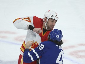 Calgary Flames' Milan Lucic fights Toronto Maple Leafs' Scott Sabourin during Tuesday's game.