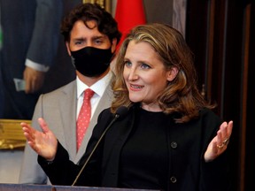 Deputy prime minister and Finance Minister Chrystia Freeland speaks to reporters next to Prime Minister Justin Trudeau on Parliament Hill in Ottawa, Aug. 18, 2020.
