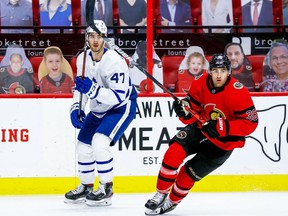 Senators centre Colin White, right, in action against the Toronto Maple Leafs on March 25, is not on the team's two-game road trip to Montreal and Winnipeg because of an unspecified upper-body injury.