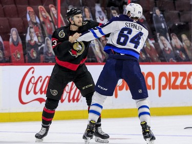 Ottawa Senators defenceman Josh Brown (left) and Winnipeg Jets defenceman Logan Stanley fight during first period NHL action at the Canadian Tire Centre.