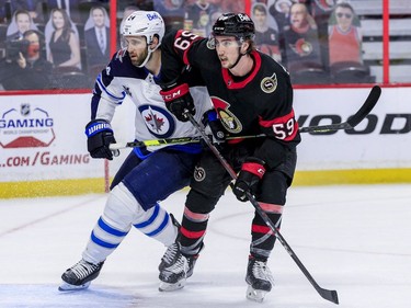 Ottawa Senators left wing Alex Formenton (right) battles with Winnipeg Jets defenceman Derek Forbort during first period NHL action at the Canadian Tire Centre.