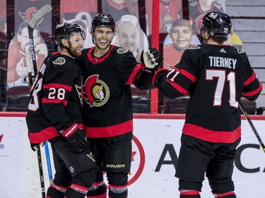 Ottawa Senators right wing Connor Brown (28) is congratulated on his goal against the Winnipeg Jets by teammates Artem Zub (2) and Chris Tierney (71) during first period NHL action at the Canadian Tire Centre.