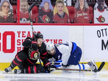 Ottawa Senators right wing Connor Brown (left) gets tangled up with Winnipeg Jets defenceman Dylan DeMelo during second period NHL action at the Canadian Tire Centre.