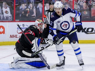 -OTTAWA- April 12,2021. Ottawa Senators goaltender Anton Forsberg (31) makes a save as Winnipeg Jets center Mason Appleton (22) eyes the rebound during second period NHL action at the Canadian Tire Centre. ERROL MCGIHON/Postmedia