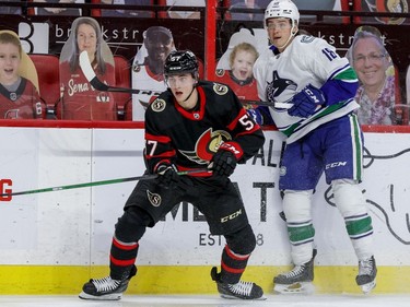 Ottawa Senators centre Shane Pinto (57) and Vancouver Canucks right wing Jake Virtanen (18) during first period NHL action at the Canadian Tire Centre.