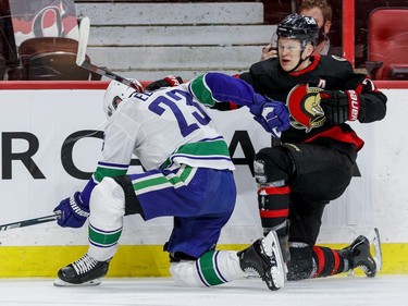 Ottawa Senators left wing Brady Tkachuk (7) checks Vancouver Canucks defenceman Alexander Edler (23) during first period NHL action at the Canadian Tire Centre.