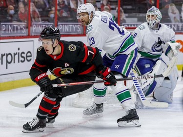 Ottawa Senators left wing Brady Tkachuk (7) and Vancouver Canucks defenceman Alexander Edler (23) in front of Vancouver Canucks goaltender Braden Holtby (49) during first period NHL action at the Canadian Tire Centre.