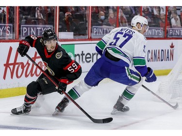 Ottawa Senators left wing Alex Formenton (59) and Vancouver Canucks defenceman Tyler Myers (57) during first period NHL action at the Canadian Tire Centre. on Monday.