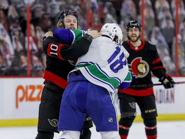 Ottawa Senators left wing Ryan Dzingel (10) fights Vancouver Canucks right wing Jake Virtanen (18) during first period NHL action at the Canadian Tire Centre.