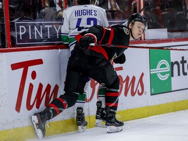 Ottawa Senators left wing Brady Tkachuk (7) checks Vancouver Canucks defenceman Quinn Hughes (43) during first period NHL action at the Canadian Tire Centre.