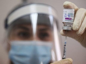 A medical worker fills a syringe with the AstraZeneca vaccine at a hospital in Tbilisi, Georgia, Tuesday, March 16, 2021.