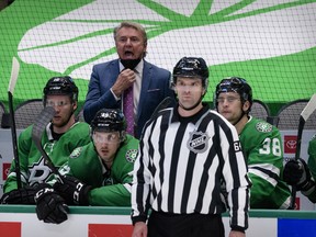 Despite having already received both vaccines, Dallas Stars coach Rick Bowness (centre) left the bench after the second period of Sunday’s 1-0 loss to the Carolina Hurricanes due to COVID protocols.