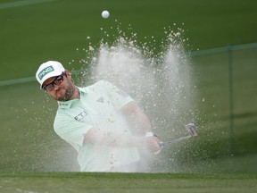Canada's Corey Conners plays out from the bunker onto the second green during the third round of The Masters at Augusta, Ga., on Saturday, April 10.
