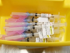 University Health Network healthcare technicians prepare syringes of the Pfizer-BioNTech COVID-19 vaccine for frontline workers in Toronto, Thursday, Jan. 7, 2021.