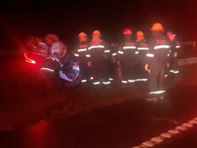 Rescue personnel work at the scene of a traffic accident where Argentina's Transport Minister Mario Meoni died, in San Andres de Giles, Buenos Aires Province, Argentina, April 23, 2021, in this still image from video obtained via social media.