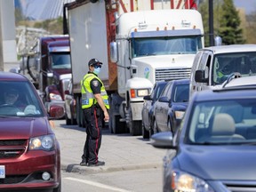 An Ottawa Police Service officer monitors traffic on King Edward Avenue