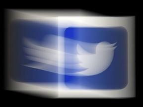 In this file illustration photo taken on August 10, 2020, a Twitter logo is displayed on a mobile phone in Arlington, Virginia.