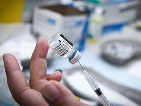 A medical worker prepares a dose in a syringe of the Pfizer/BioNTech vaccine