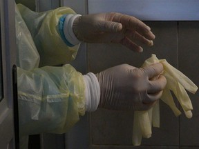 A health worker exits a COVID-19 Intensive Care Unit (ICU).