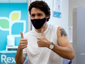 Canada's Prime Minister Justin Trudeau reacts after being inoculated with AstraZeneca's vaccine against coronavirus disease (COVID-19) at a pharmacy in Ottawa,  April 23, 2021.
