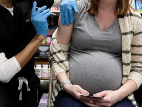 A pregnant woman receives a vaccine for the coronavirus disease (COVID-19).