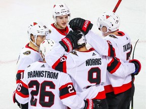 Some of the talented young Ottawa Senators — Erik Brannstrom, Tim Stuetzle (18), Drake Batherson (19), Brady Tkachuk (7) and Josh Norris — celebrate after a Norris goal against Calgary on Monday.