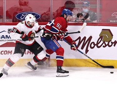 Montreal Canadiens left wing Jonathan Drouin (92) plays the puck against Ottawa Senators left wing Victore Mete (98) during the first period at Bell Centre.
