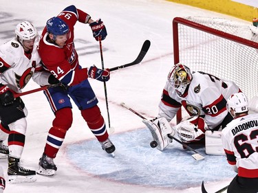 Ottawa Senators goaltender Matt Murray (30) makes a save against Montreal Canadiens right wing Corey Perry (94) as defenceman Thomas Chabot (72) defends during the second period at Bell Centre in Montreal.