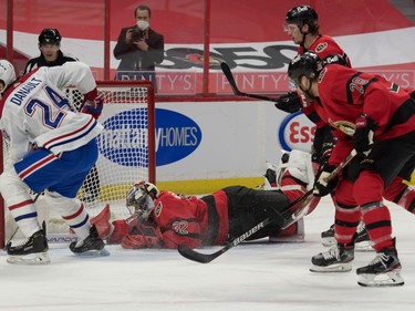 Montreal Canadiens center Phillip Danault (24) scores against Ottawa Senators goalie Filip Gustavsson (32) in the first period at the Canadian Tire Centre.