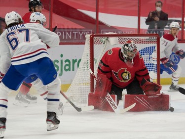 Ottawa Senators goalie Filip Gustavsson (32) makes a save on a shot from Montreal Canadiens right wing Michael Frolik (67) in the first period at the Canadian Tire Centre.