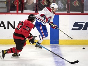 Canadiens defenceman Brett Kulak skates with the puck as he's chased by Senators forward Nick Paul in the third period.