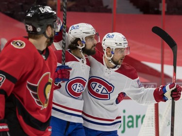 Montreal Canadiens center Phillip Danault (24) celebrates with left wing Thomas Tatar (90) as Ottawa Senators right wing Connor Brown (28) skates past in the first period at the Canadian Tire Centre.