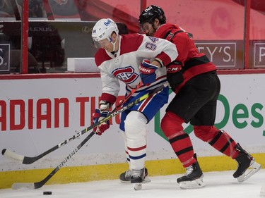 Montreal Canadiens left wing Alexander Barabanov (94) battles with Ottawa Senators defenseman Josh Brown (3) for control of the puck in the first period at the Canadian Tire Centre.