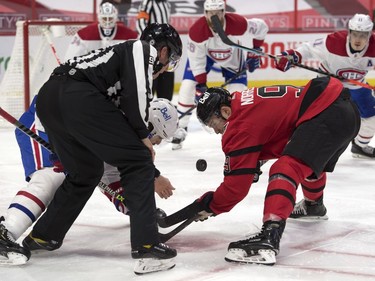 Montreal Canadiens center Phillip Danault (24] faces off against Ottawa Senators center Josh Norris (9) in the second period at the Canadian Tire Centre.