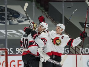 Ottawa Senators goalie Matt Murray (30) and forward Drake Batherson (19) and forward Brady Tkachuk (7) celebrate their victory against the Vancouver Canucks in the third period at Rogers Arena on April 22, 2021.