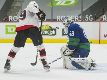 Vancouver Canucks goalie Braden Holtby (49) makes a save on Ottawa Senators forward Drake Batherson (19) in the third period at Rogers Arena. Canucks won 4-2.