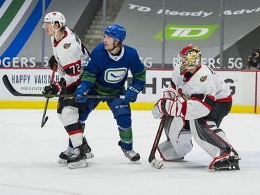 Apr 24, 2021; Vancouver, British Columbia, CAN; Ottawa Senators defenseman Thomas Chabot (72) battles with Vancouver Canucks forward Brock Boeser (6) in front of  goalie Marcus Hogberg (1) in the second period at Rogers Arena. Mandatory Credit: Bob Frid-USA TODAY Sports ORG XMIT: IMAGN-445658