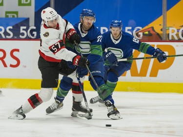 Vancouver Canucks forward Travis Boyd (72) skates against Ottawa Senators forward Shane Pinto (57) in the first period at Rogers Arena.