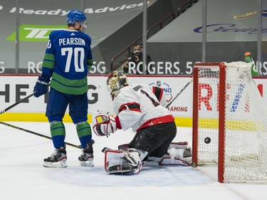 Vancouver Canucks forward Tanner Pearson (70) watches the shot from  forward Brock Boeser (6) beat Ottawa Senators goalie Marcus Hogberg (1) in the second period at Rogers Arena.