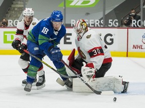 Ottawa Senators defenseman Thomas Chabot (72) checks Vancouver Canucks forward Jake Virtanen (18) as goalie Matt Murray (30) makes a save in the second period at Rogers Arena.