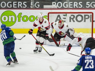Apr 24, 2021; Vancouver, British Columbia, CAN; Vancouver Canucks forward Tanner Pearson (70) scores the game winning goal on Ottawa Senators goalie Marcus Hogberg (1) as defenseman Thomas Chabot (72) attempts the block in the third period at Rogers Arena. Canucks won 4-2.  Mandatory Credit: Bob Frid-USA TODAY Sports ORG XMIT: IMAGN-445658