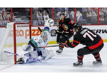 Vancouver Canucks goaltender Thatcher Demko makes a save off of Ottawa Senators centre Chris Tierney (71) as right wing Connor Brown (28) follows the play during the third period.
