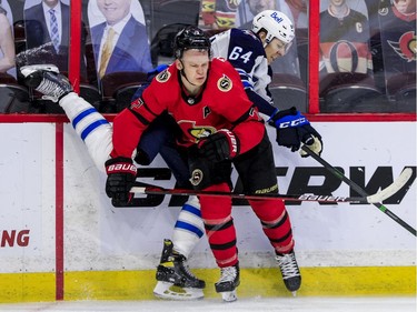 Ottawa Senators left wing Brady Tkachuk (7) checks Winnipeg Jets defenceman Logan Stanley.
