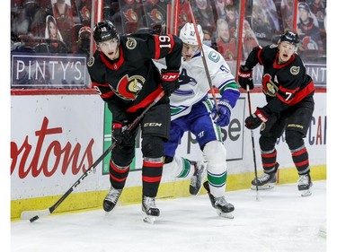 Ottawa Senators right wing Drake Batherson (19) eludes the check of Vancouver Canucks defenceman Tyler Myers (57) as Ottawa Senators left wing Brady Tkachuk (7) follows the play during the third period.