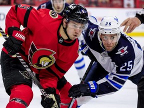 Ottawa Senators centre Josh Norris (9) wins a faceoff against Winnipeg Jets centre Paul Stastny.