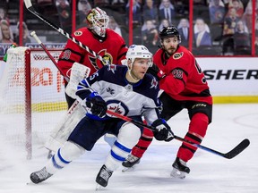 Ottawa Senators defenceman Victor Mete (right) and Winnipeg Jets centre Paul Stastny in front of Ottawa Senators goaltender Matt Murray, April 14, 2021.