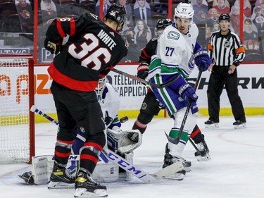 Ottawa Senators centre Colin White (36) is stopped by Vancouver Canucks goaltender Thatcher Demko (35) as defenceman Travis Hamonic (27) follows the play.