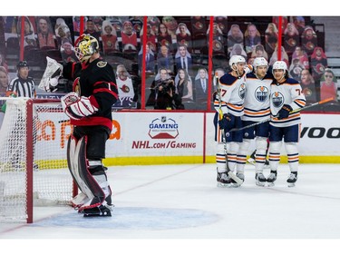 Edmonton Oilers Connor McDavid (97), Leon Draisaitl (29), and Ethan Bear celebrate Draisaitl's second goal of the game as Ottawa Senators goaltender Marcus Hogberg (1) looks on.